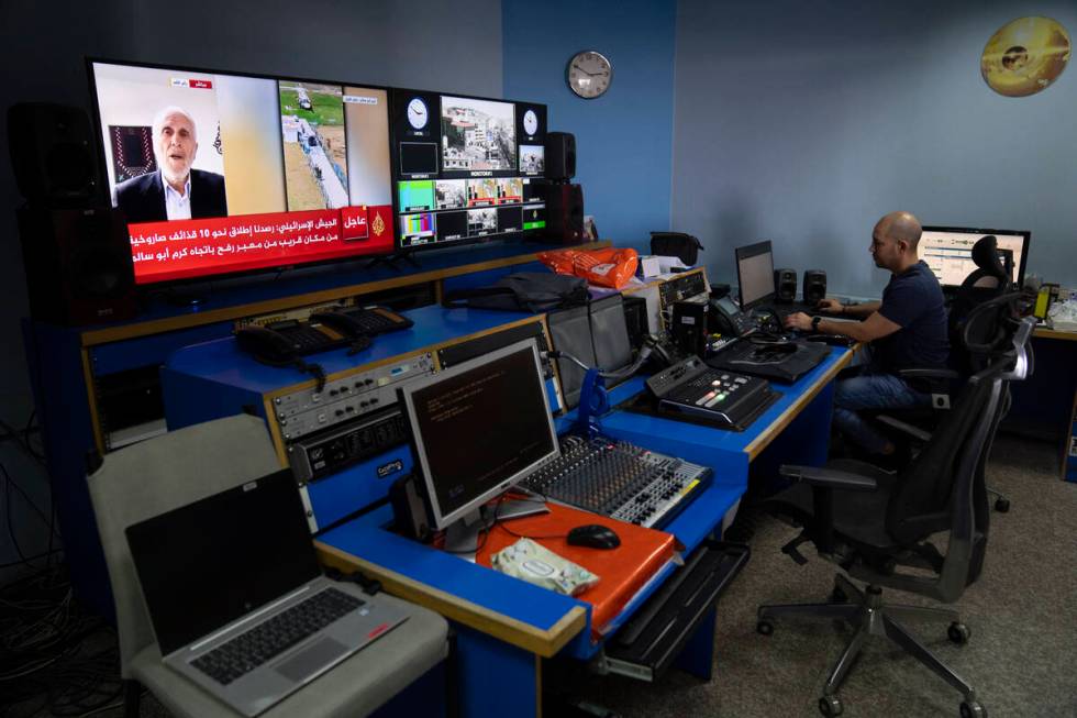 FILE- Al Jazeera broadcast engineer Mohammad Salameh works at the Master Control Room unit insi ...