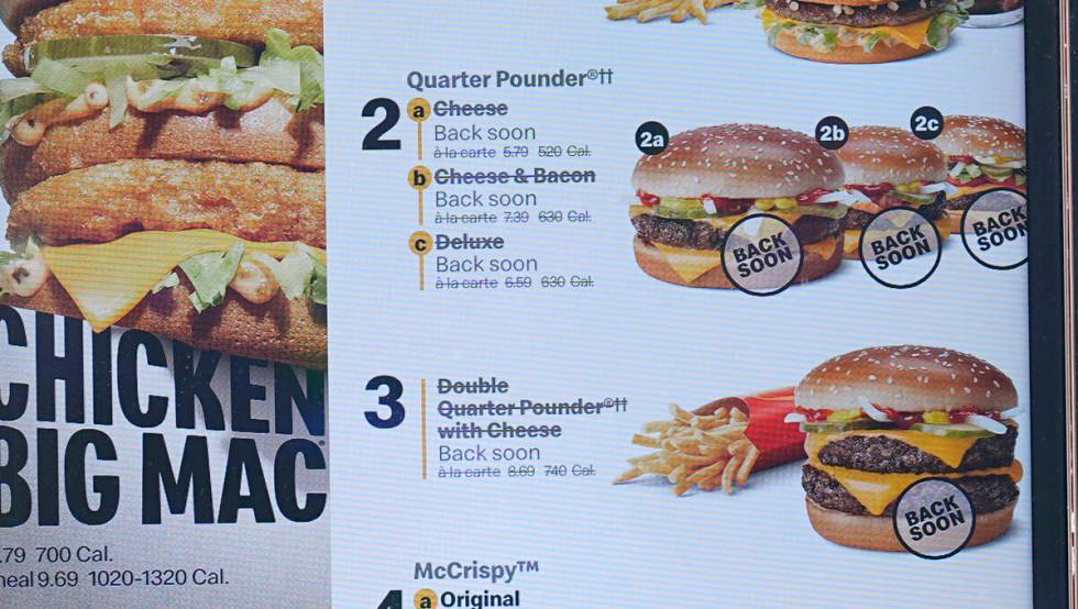 The electronic menu order board still displays Quarter Pounder hamburgers but with a prompt to ...