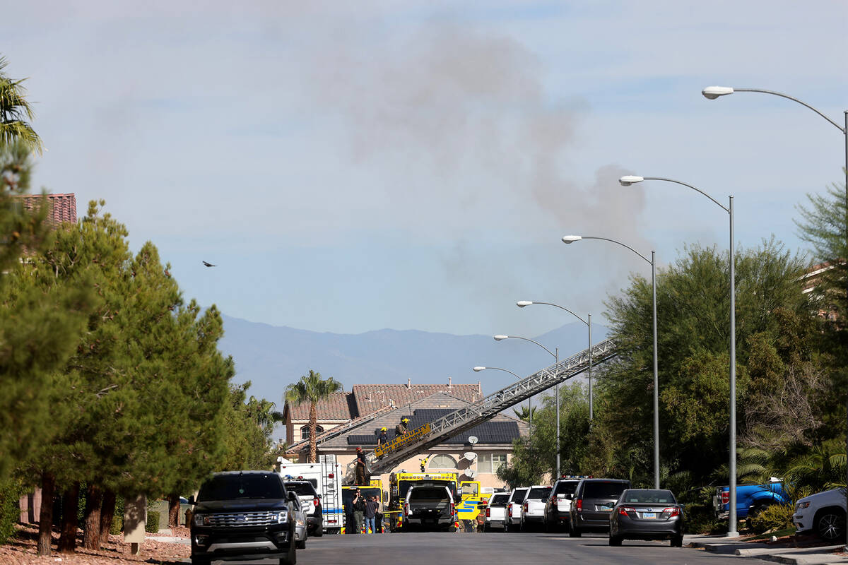 Clark County firefighters work at the scene of a house fire in the 8300 block of Langhorne Cree ...