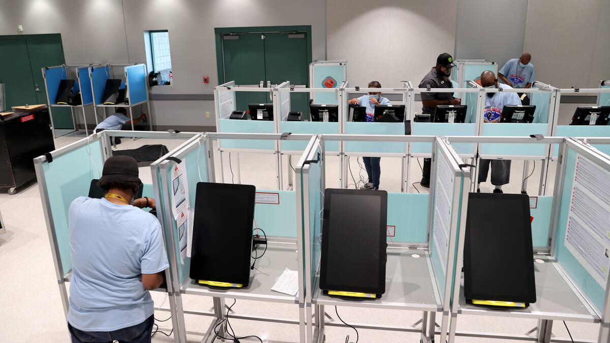 Clark County election workers set up voting booths at the Cora Coleman Senior Center in Las Veg ...