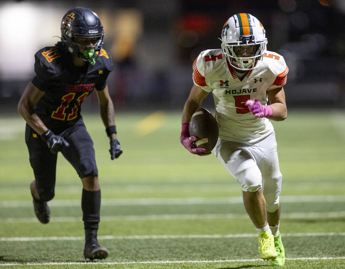 Mojave senior Miguel Reinares (5) runs a reception to the end zone during the high school 4A De ...