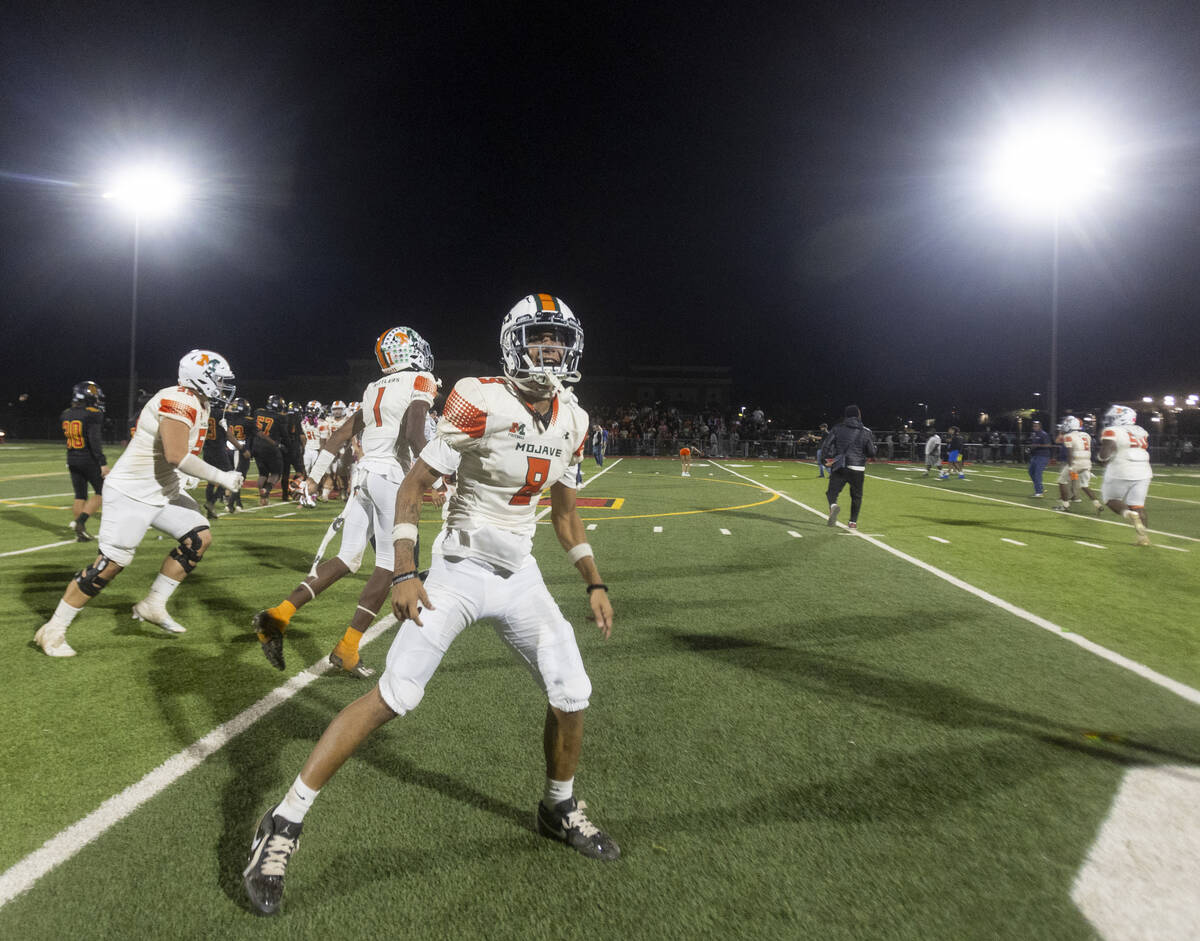 Mojave senior Peyton Parnell (8) celebrates after the high school 4A Desert League title footba ...