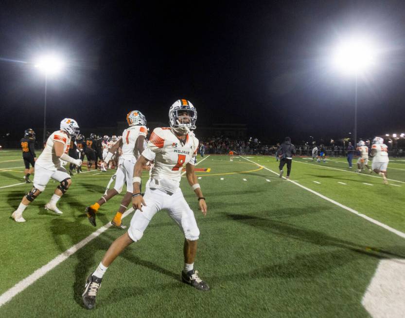 Mojave senior Peyton Parnell (8) celebrates after the high school 4A Desert League title footba ...