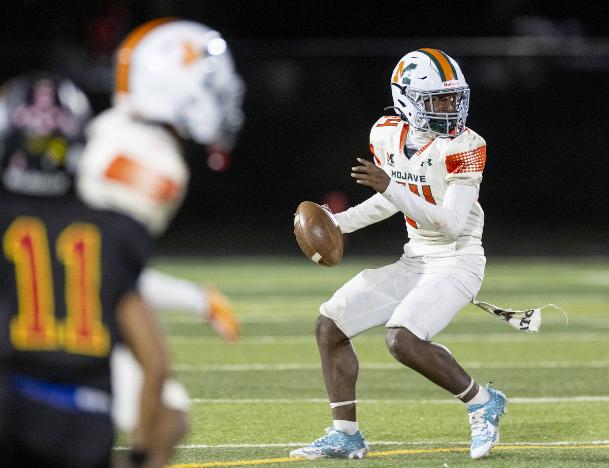 Mojave sophomore Ra'Jahn Butler (24) looks to throw the ball during the high school 4A Desert L ...