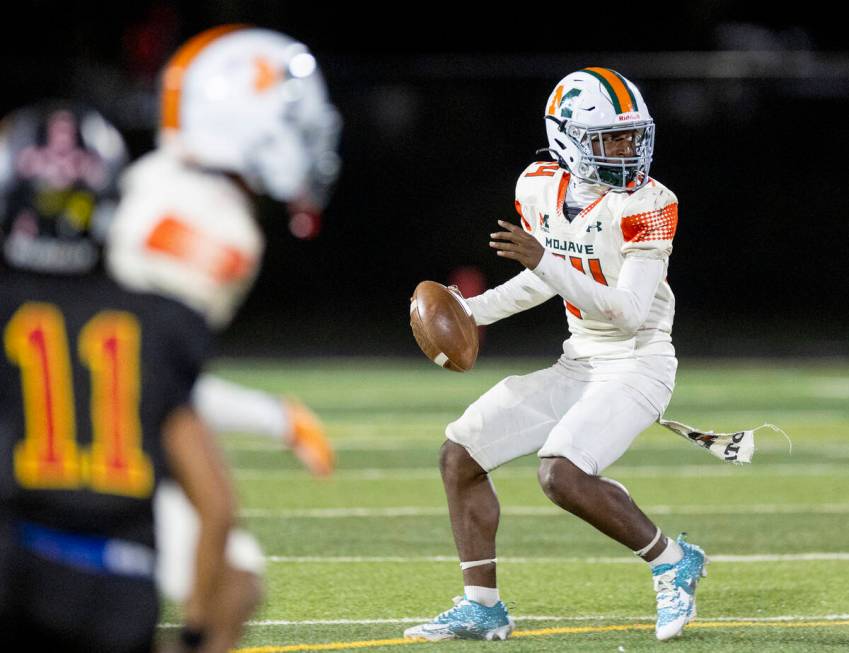 Mojave sophomore Ra'Jahn Butler (24) looks to throw the ball during the high school 4A Desert L ...