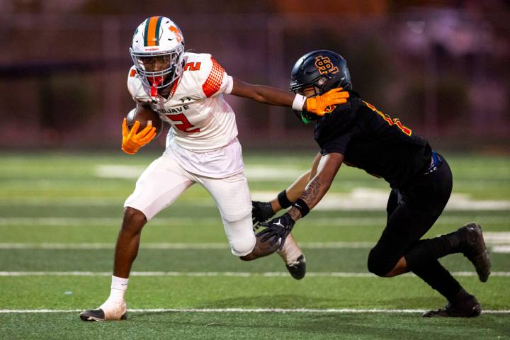 Mojave senior Arthur AJ Williams (2) avoids a tackle during the high school 4A Desert League ti ...