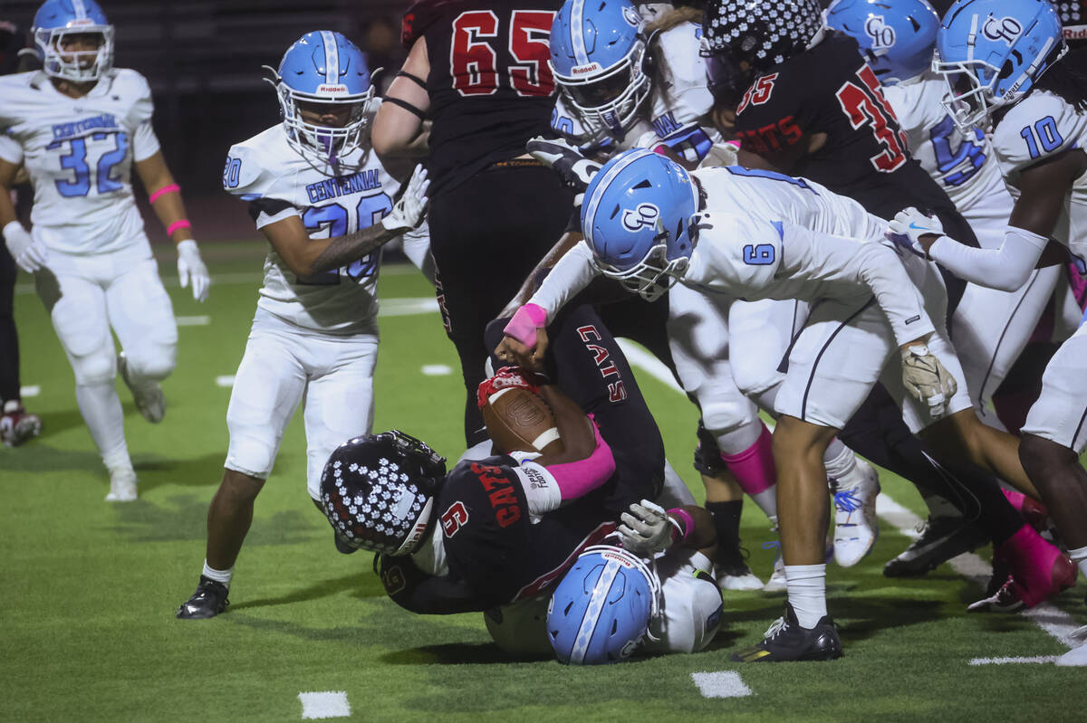 Las Vegas outside linebacker Christopher Boddy Jr. (9) gets tackled by Centennial during a foot ...