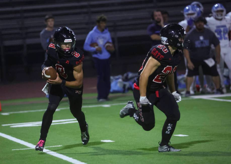 Las Vegas quarterback Tanner Vibabul (8) looks to pass the ball during a football game against ...