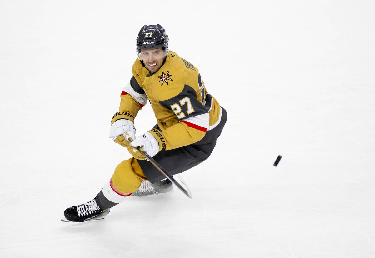 Vegas Golden Knights defenseman Shea Theodore (27) chases the puck during the NHL hockey game a ...