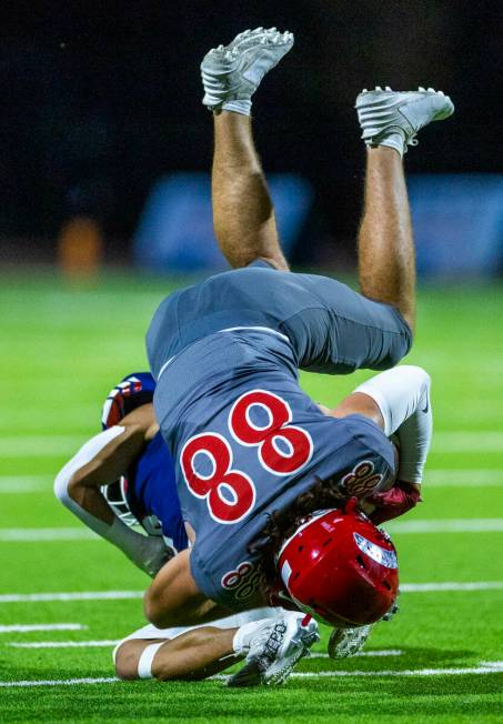 Arbor View tight end Zac Fares (88) flips over Liberty defender Skyler Jackson (9) on a stop du ...