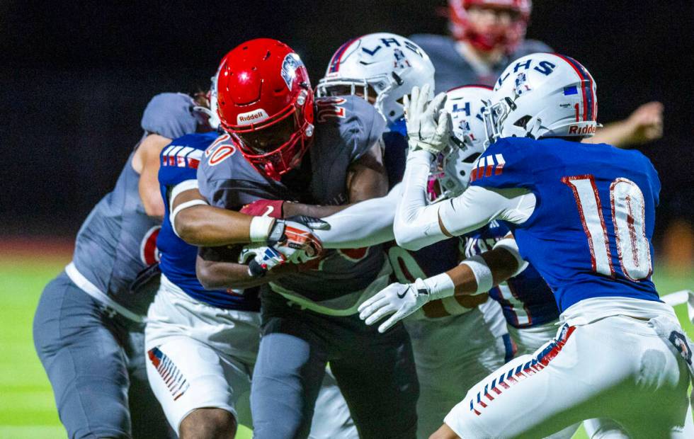 Arbor View running back Kamareion Bell (20) looks for yards as Liberty defenders attempt to mak ...