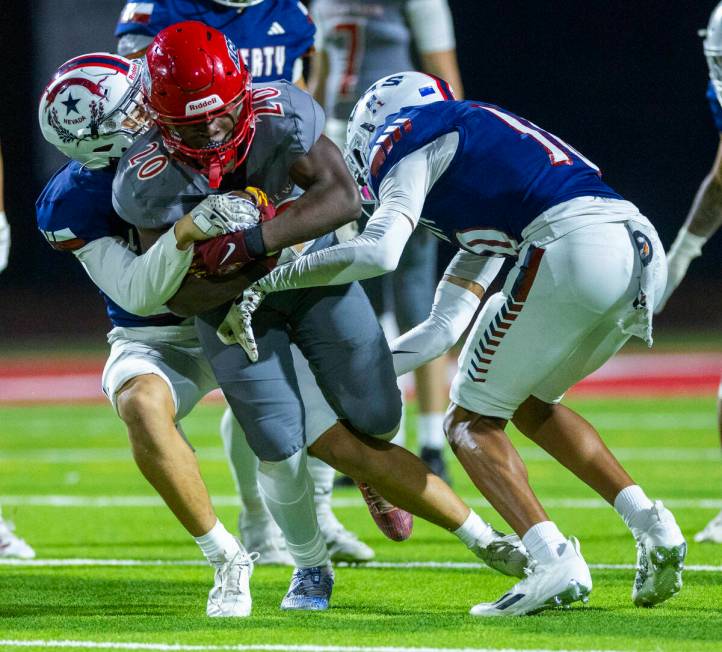 Arbor View running back Kamareion Bell (20) looks for yards as Liberty defenders attempt to mak ...