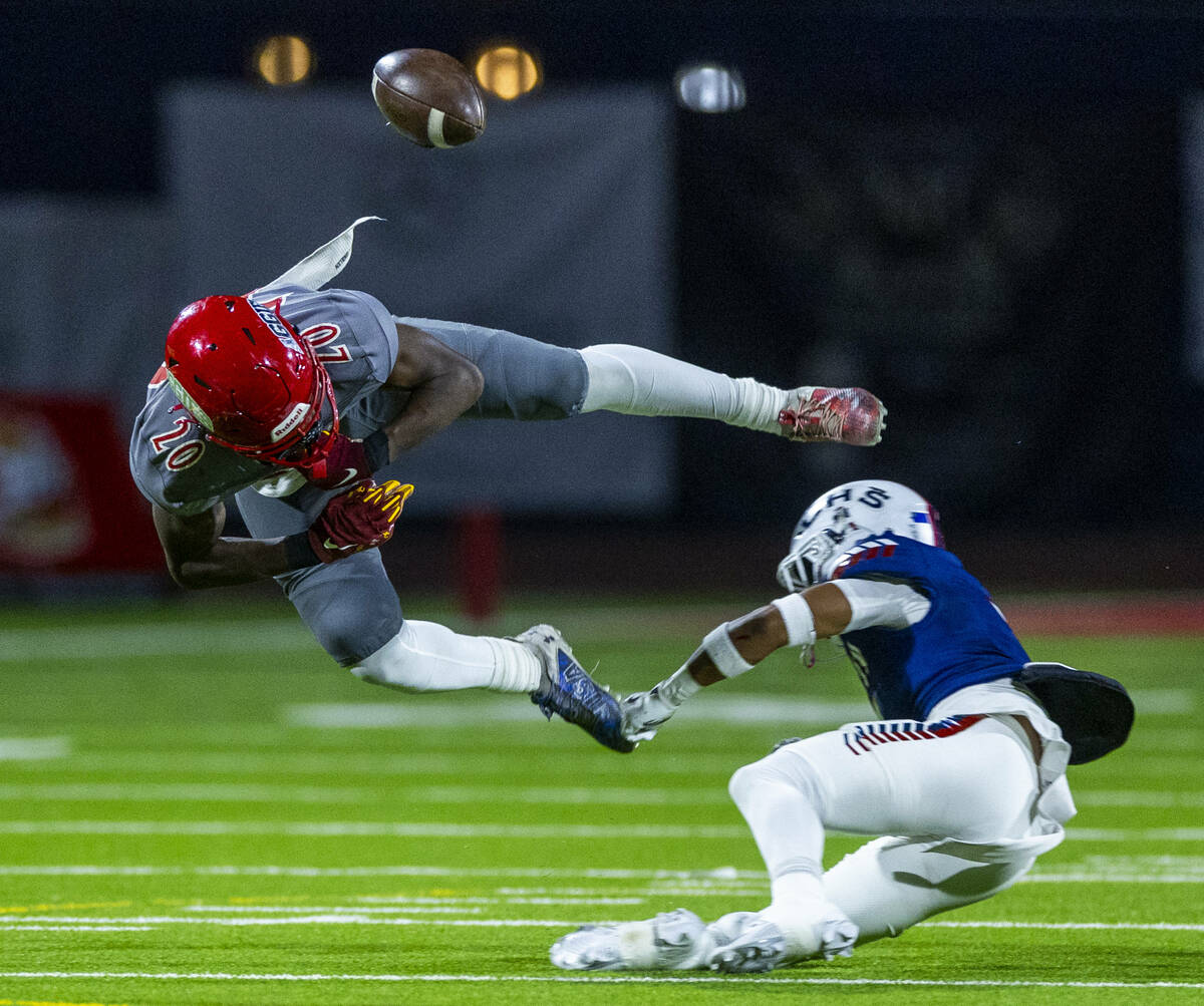 Arbor View running back Kamareion Bell (20) fumbles the ball after a big hit by Liberty defende ...