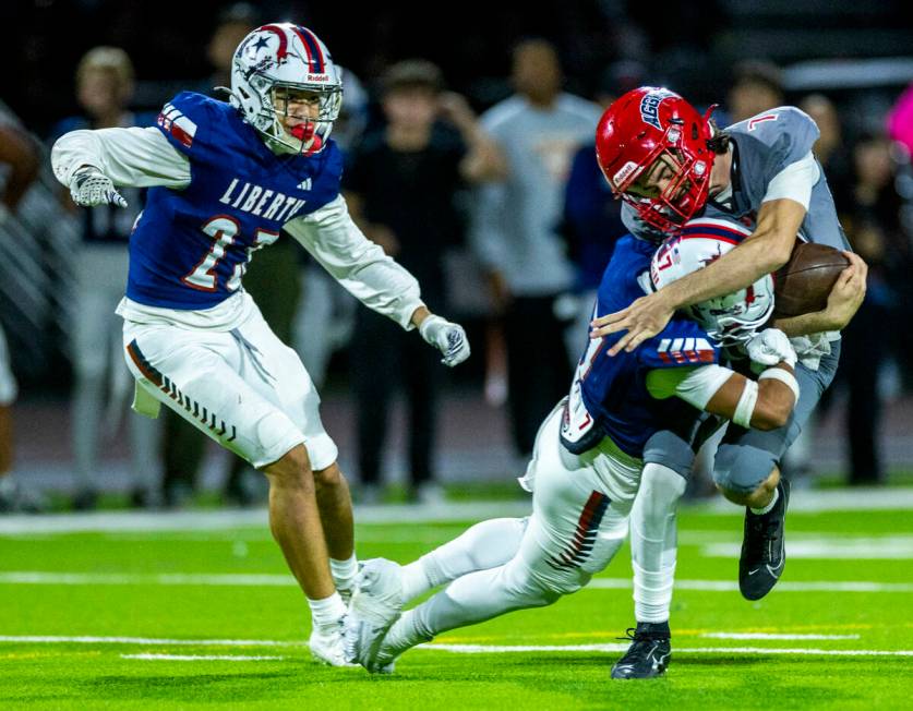 Arbor View quarterback Thaddeus Thatcher (7) takes on Liberty defensive back Gravis Lopez (7) f ...