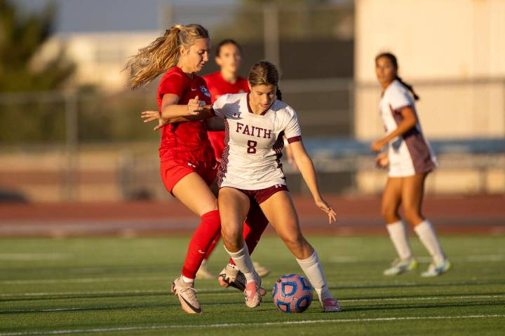 Faith Lutheran forward Olivia Stark (8) attempts to keep the ball from Coronado midfielder Alex ...