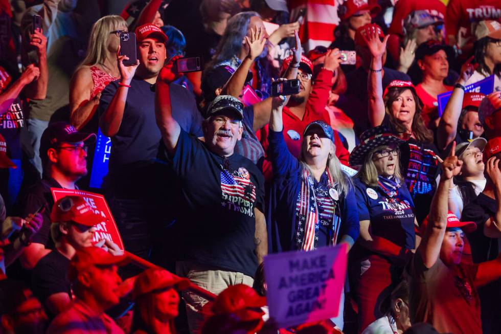 Supporters of Republican presidential nominee former President Donald Trump sing during Turning ...