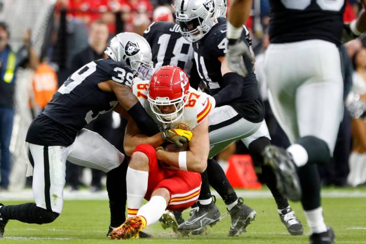 Kansas City Chiefs tight end Travis Kelce (87) is taken down by Raiders defense during the firs ...