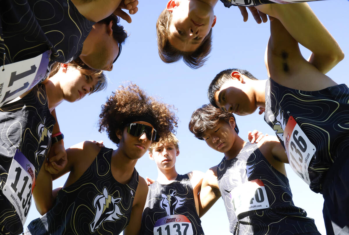 Clark High School runners pray before participating in the 4A Mountain boys cross country meet ...