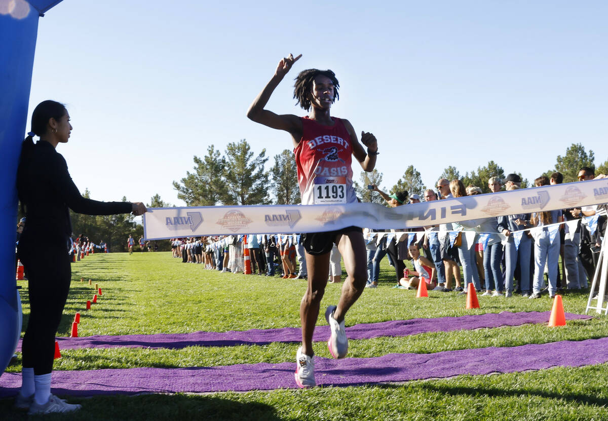 Kenan Dagge of Desert Oasis crosses the finish line during the 5A Southern Region boys cross co ...