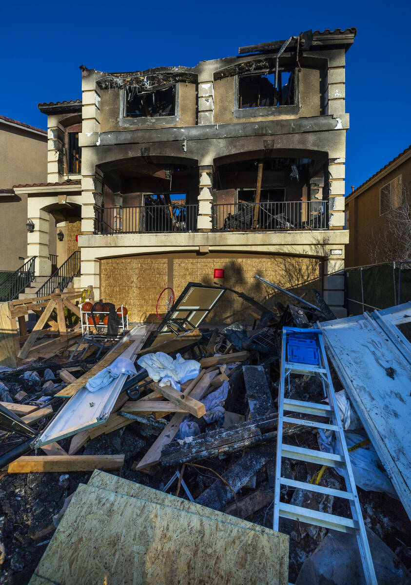 Debris is piled up on the exterior of fatal house fire at 8332 Langhorne Creek Street on Friday ...