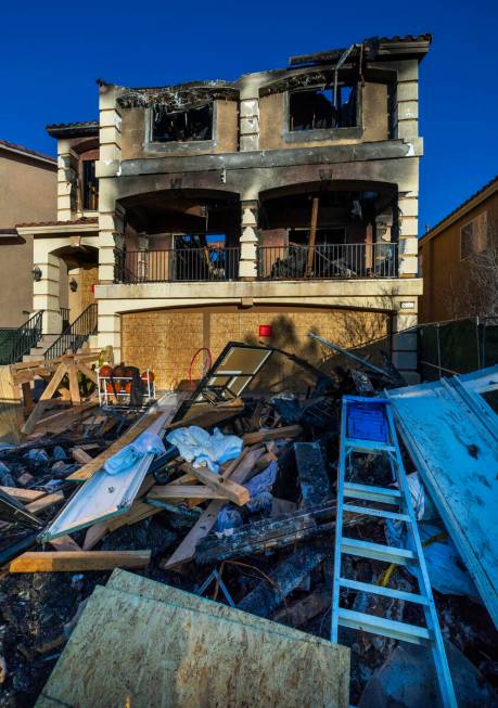 Debris is piled up on the exterior of fatal house fire at 8332 Langhorne Creek Street on Friday ...