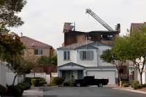 The remains of a charred house are seen after an early morning fire at 8332 Langhorne Creek Str ...