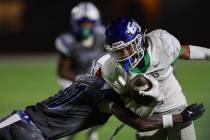 Basic’s Terrion Foster (10) tackles Green Valley’s Trey Glasper (1) while he carr ...