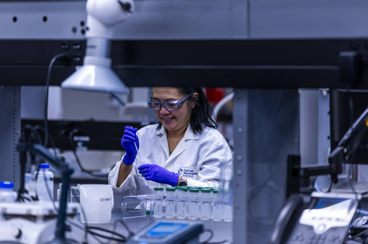 A technician prepares water samples for testing at the lab within the Clark County Water Reclam ...