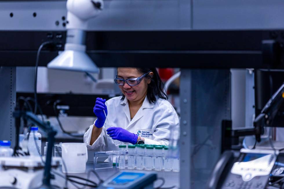 A technician prepares water samples for testing at the lab within the Clark County Water Reclam ...