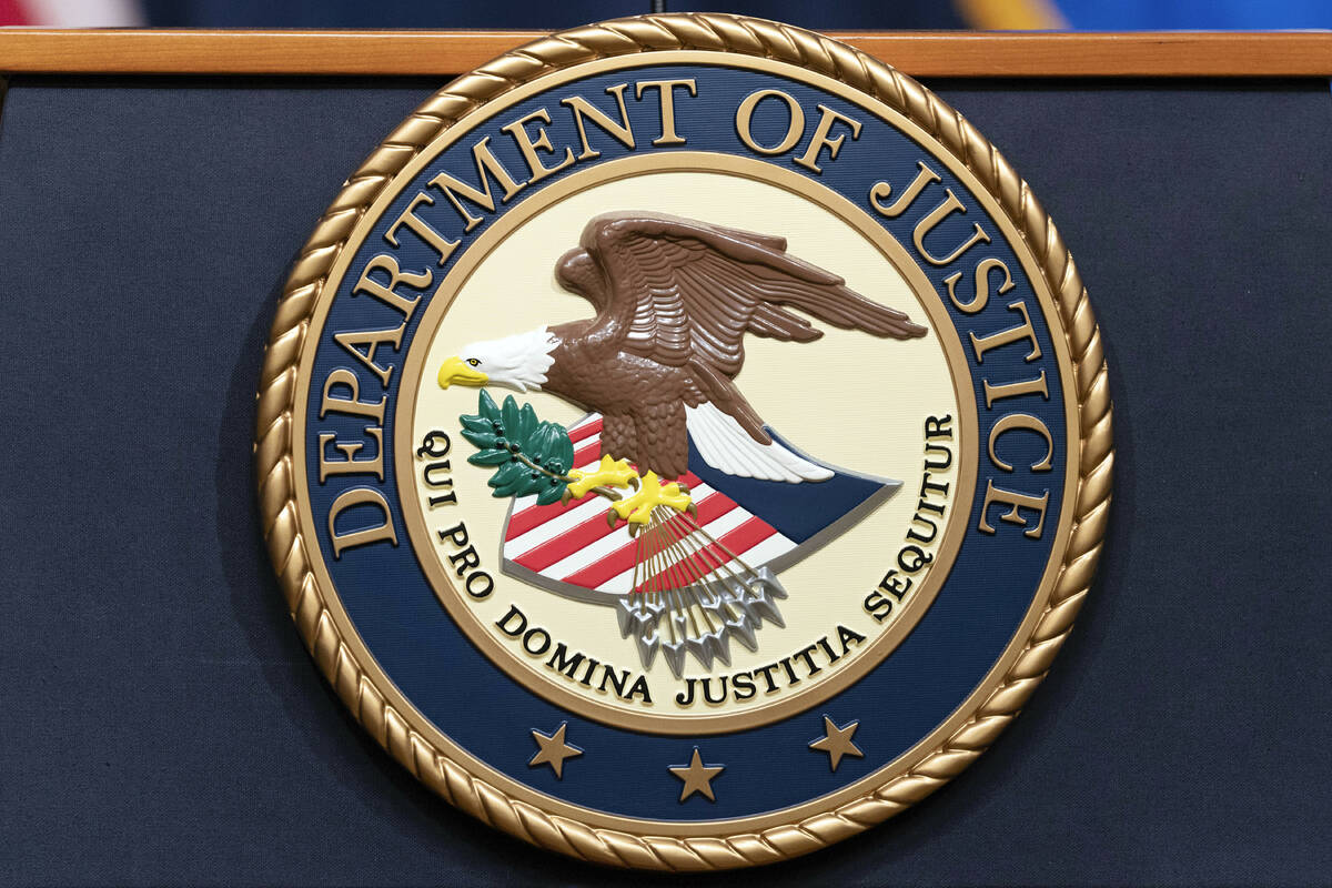 The Department of Justice seal is seen during a news conference at the DOJ office in Washington ...