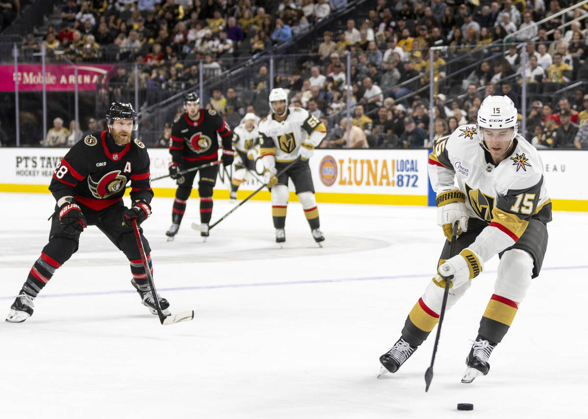 Golden Knights defenseman Noah Hanifin (15) skates with the puck during the second period of th ...