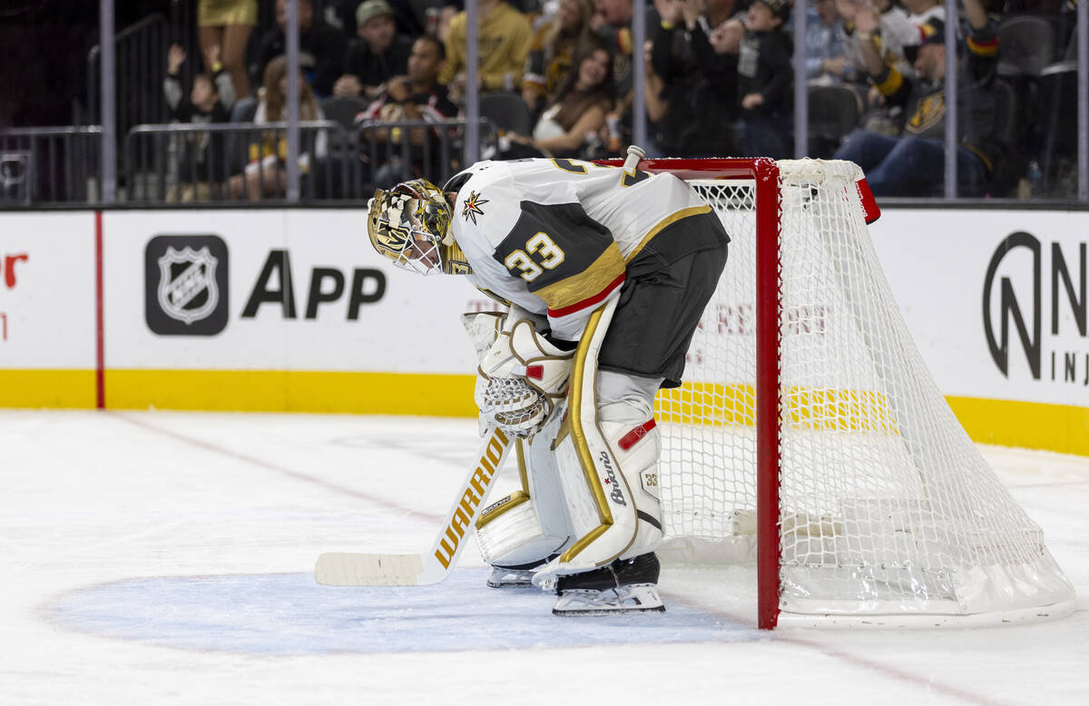 Golden Knights goaltender Adin Hill (33) bends over during a break in play during the second pe ...