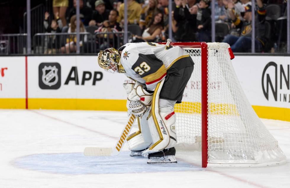 Golden Knights goaltender Adin Hill (33) bends over during a break in play during the second pe ...