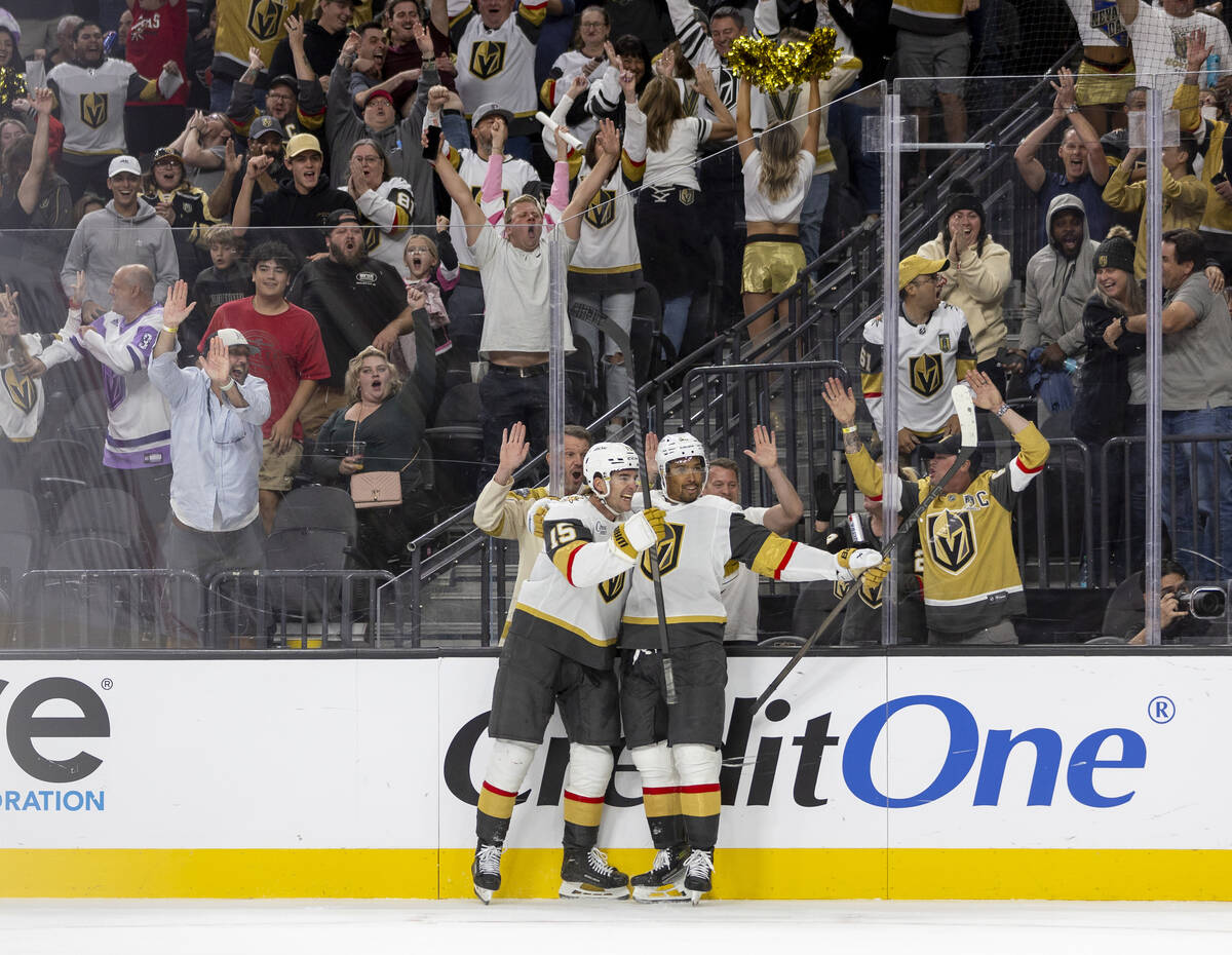 Golden Knights defenseman Noah Hanifin (15) and right wing Keegan Kolesar (55) celebrate a goal ...