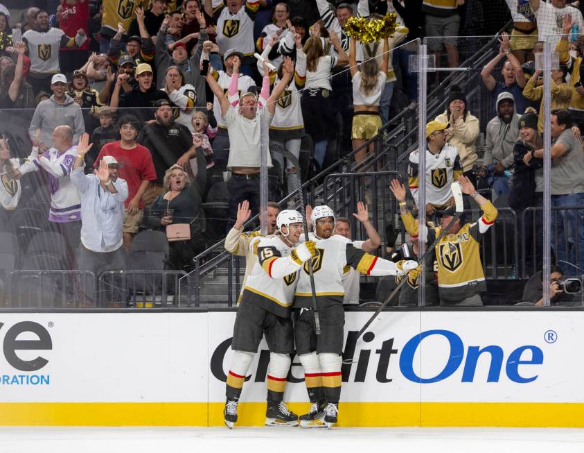 Golden Knights defenseman Noah Hanifin (15) and right wing Keegan Kolesar (55) celebrate a goal ...