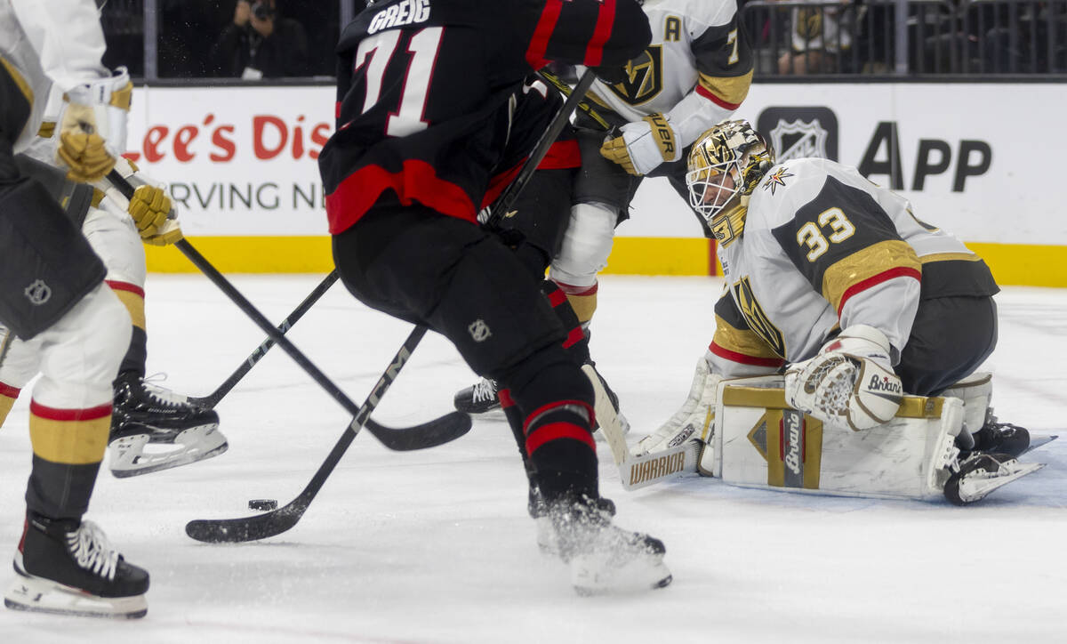 Golden Knights goaltender Adin Hill (33) tracks the puck through traffic during the NHL hockey ...