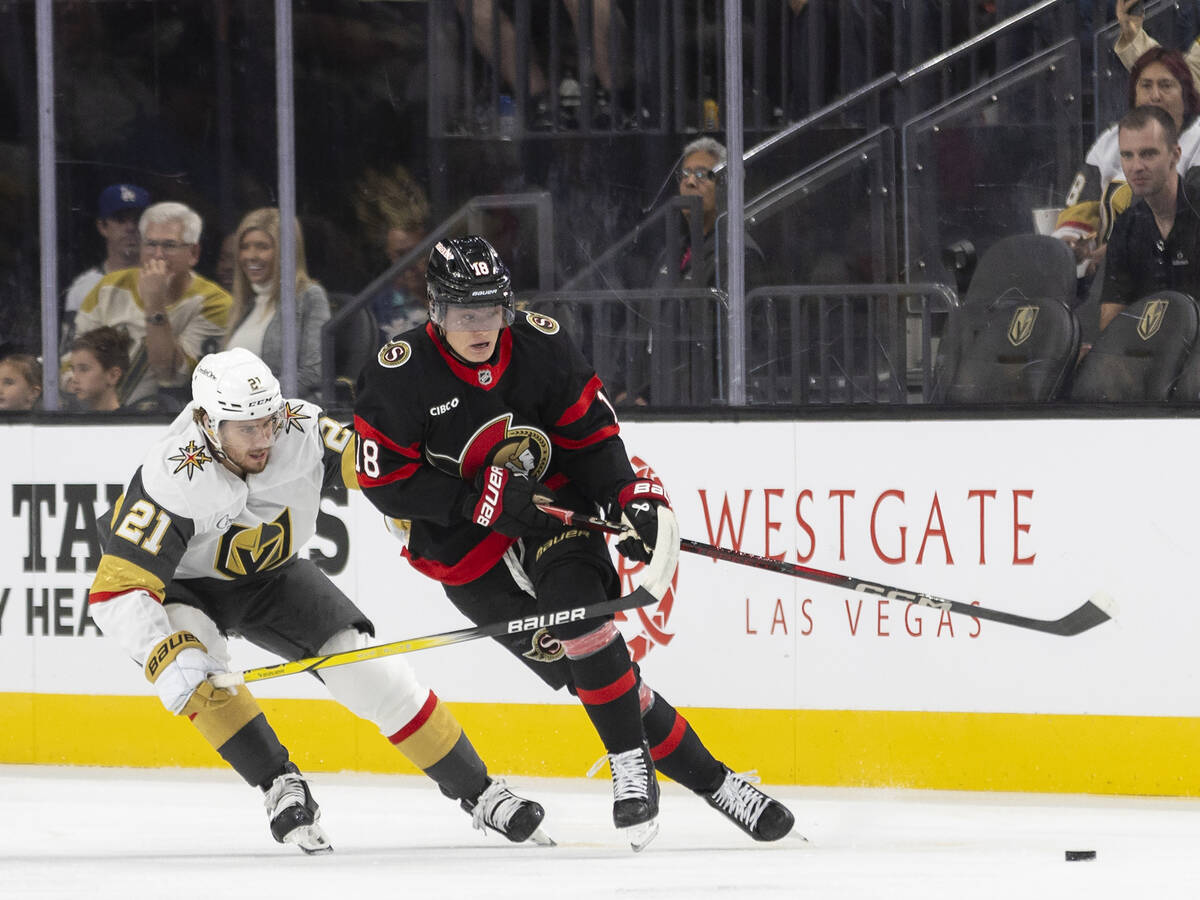 Golden Knights center Brett Howden (21) and Ottawa Senators center Tim Stützle (18) fight ...