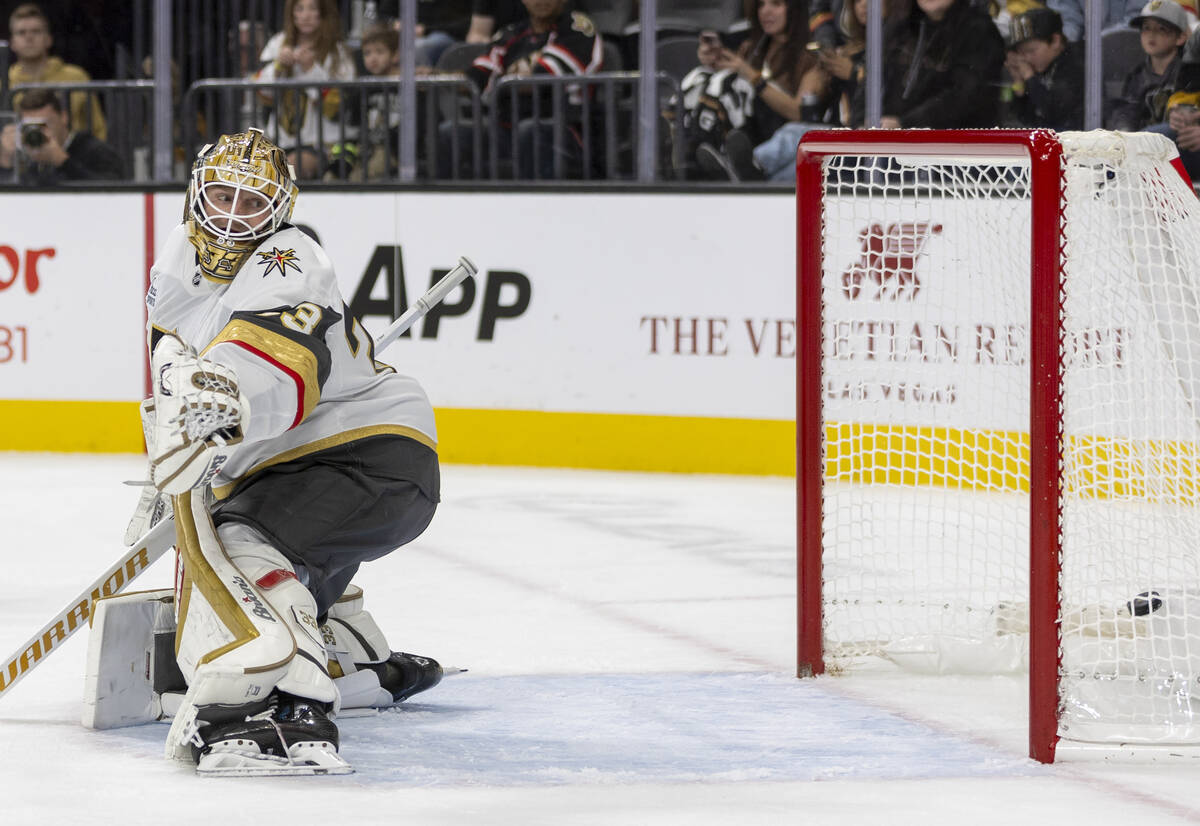 Golden Knights goaltender Adin Hill (33) watches a puck land in the net during the NHL hockey g ...