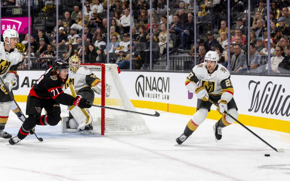 Golden Knights defenseman Shea Theodore (27) controls the puck during the NHL hockey game again ...