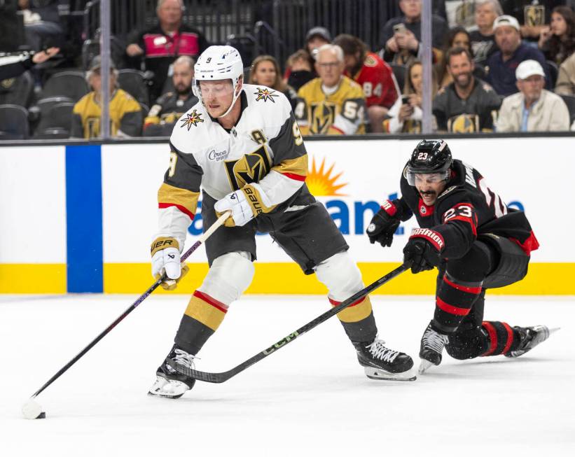 Golden Knights center Jack Eichel (9) keeps the puck away from Ottawa Senators defenseman Travi ...