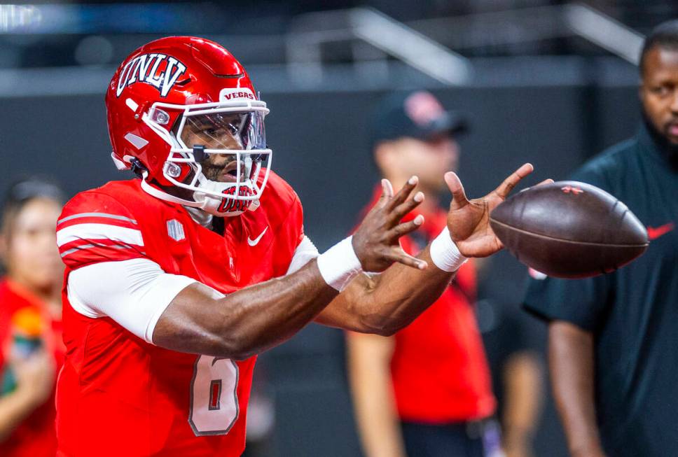 UNLV quarterback Hajj-Malik Williams (6) receives a snap during warm ups of their NCAA football ...