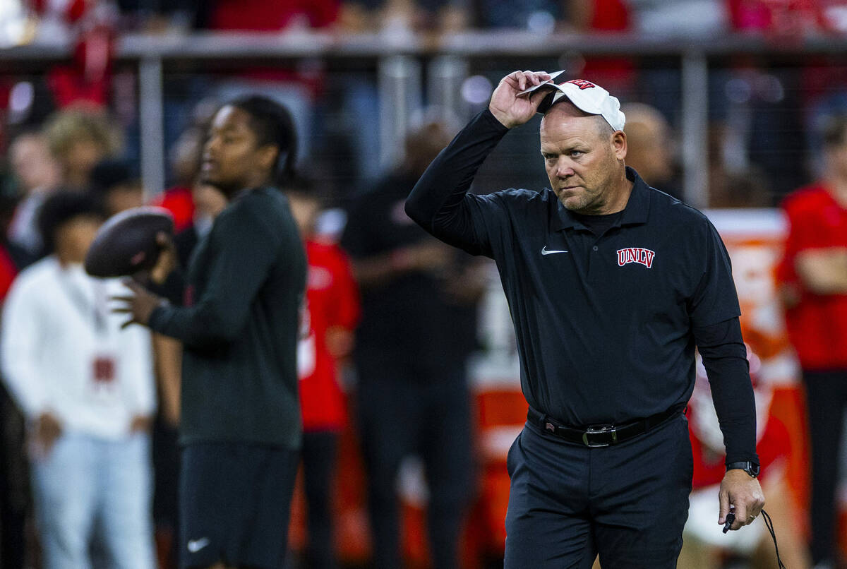 UNLV head coach Barry Odom watches his players during warm ups of their NCAA football game agai ...