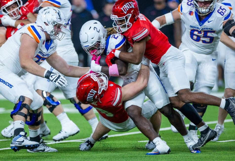 Boise State Broncos running back Ashton Jeanty (2) is stopped for a short gain by UNLV defensiv ...