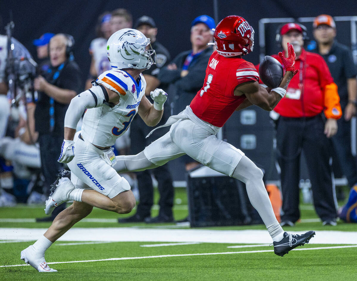 UNLV wide receiver Casey Cain (1) hauls in a long pass over Boise State Broncos safety Alexande ...