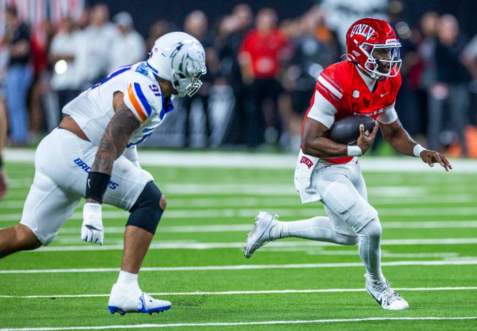 UNLV quarterback Hajj-Malik Williams (6) turns the corner on a run pursued by Boise State Bronc ...