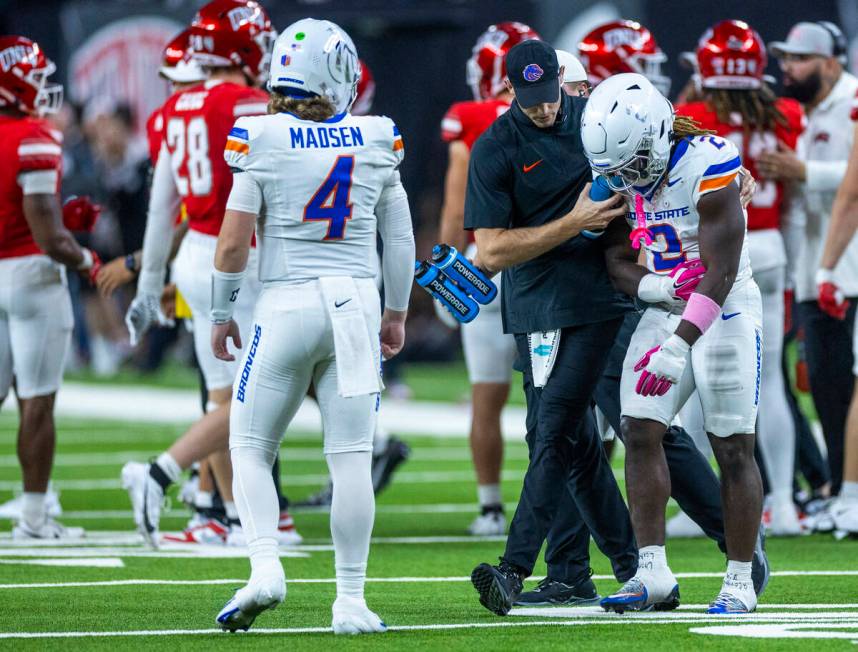 Boise State Broncos running back Ashton Jeanty (2) holds an injured arm as he's escorted off th ...