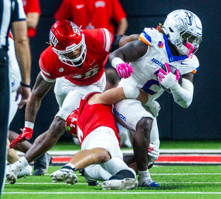 Boise State Broncos running back Ashton Jeanty (2) is turned back by UNLV linebacker Jackson Wo ...