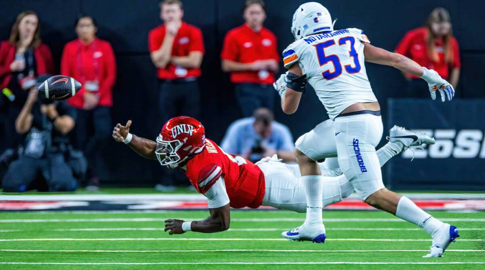 UNLV quarterback Hajj-Malik Williams (6) tosses the ball away for a penalty as Boise State Bron ...