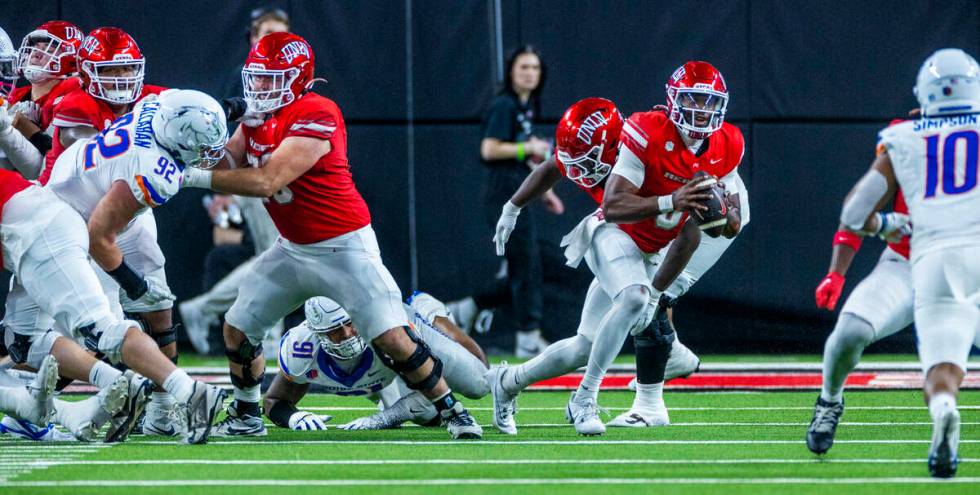 UNLV quarterback Hajj-Malik Williams (6) looks for a receiver but will run again as Boise State ...