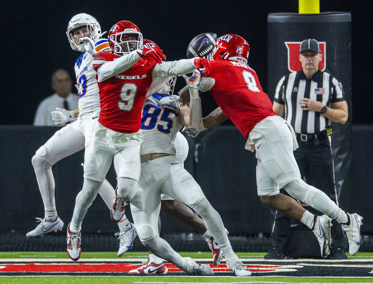 UNLV defensive back Jett Elad (9) breaks up a touchdown pass to Boise State Broncos tight end M ...